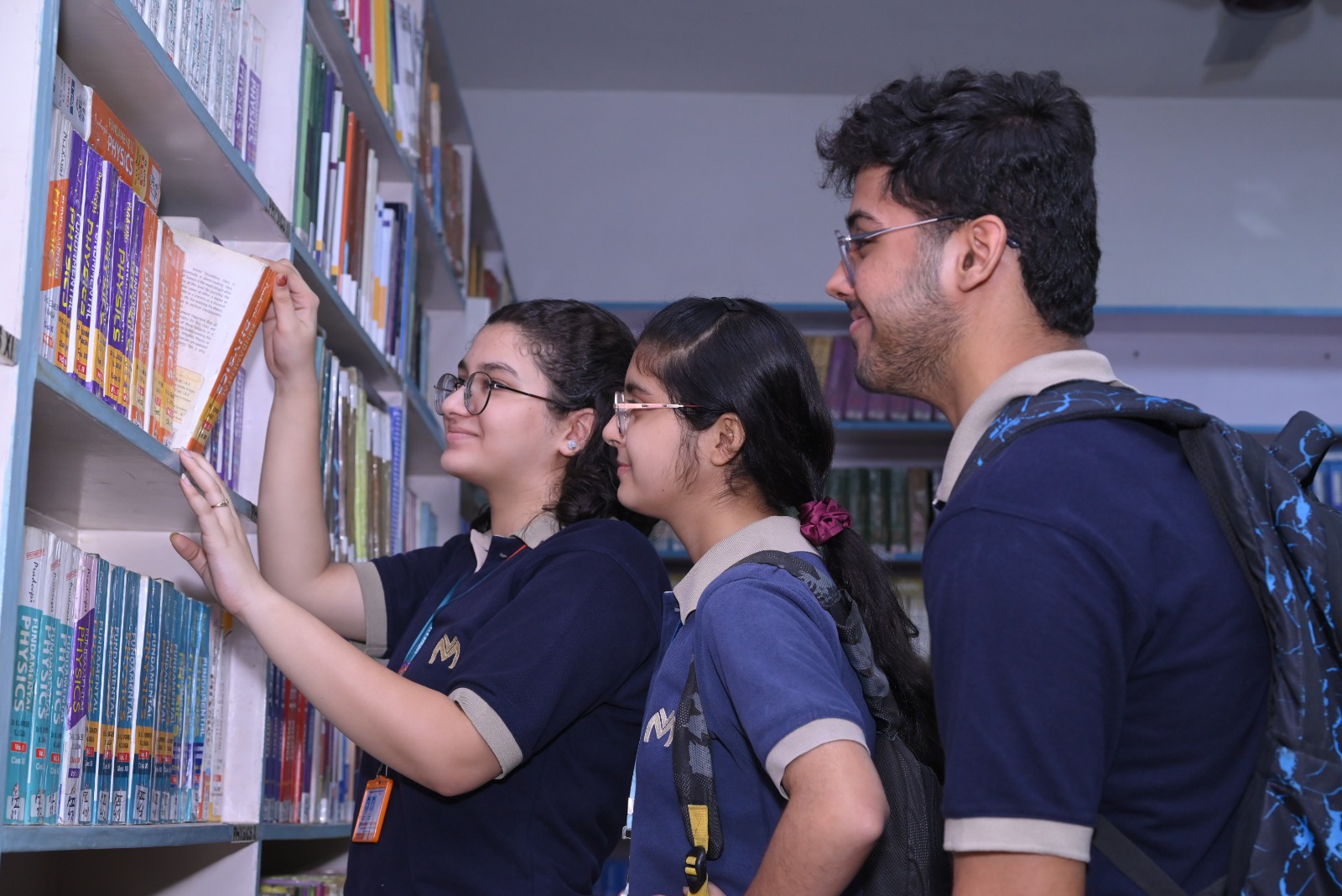 Students exploring books in the VMPS library